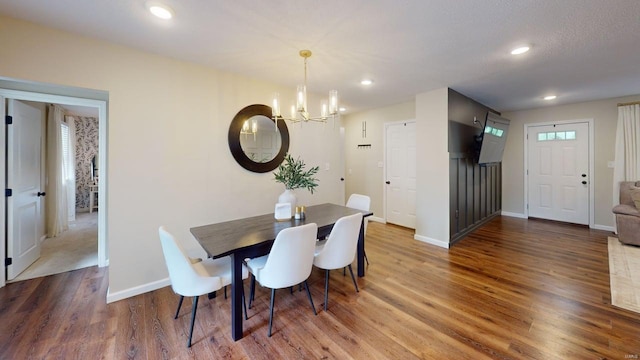 dining area with recessed lighting, baseboards, a notable chandelier, and wood finished floors