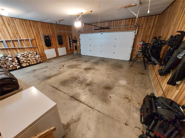 garage featuring wood walls and a garage door opener