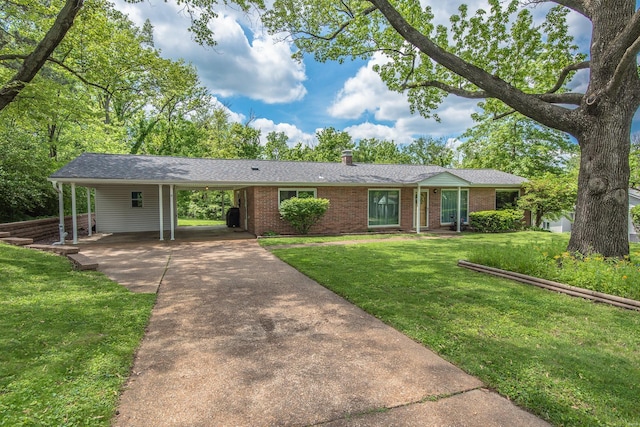 single story home with brick siding, driveway, a front yard, a carport, and a chimney