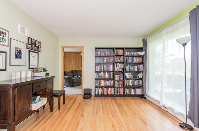 sitting room featuring visible vents and wood finished floors