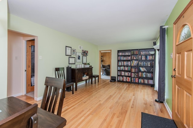 living area featuring light wood-style flooring and baseboards
