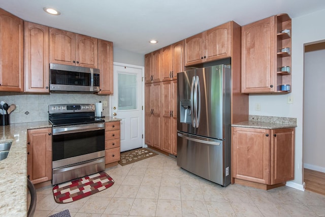 kitchen featuring stainless steel appliances, baseboards, backsplash, light stone counters, and recessed lighting