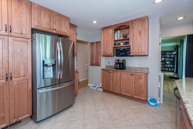kitchen with baseboards, light stone countertops, recessed lighting, and stainless steel refrigerator with ice dispenser