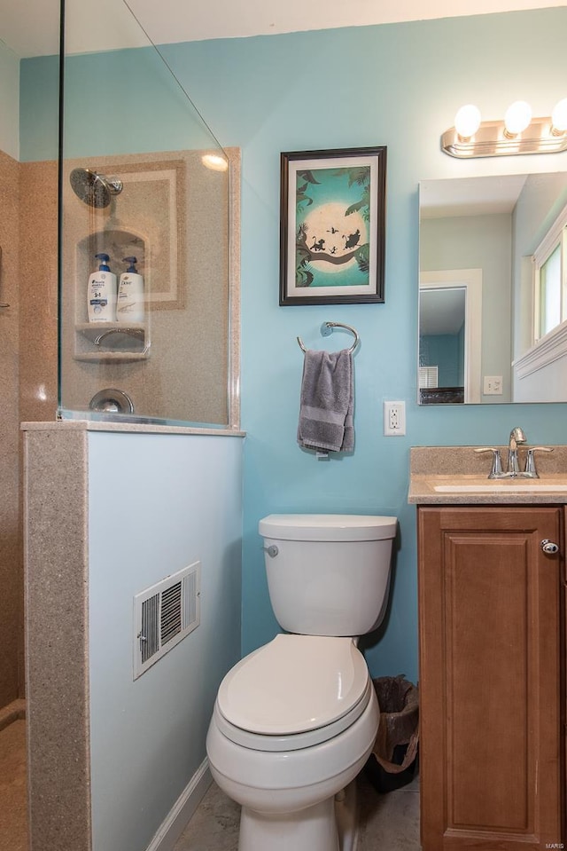 bathroom with vanity, toilet, and visible vents