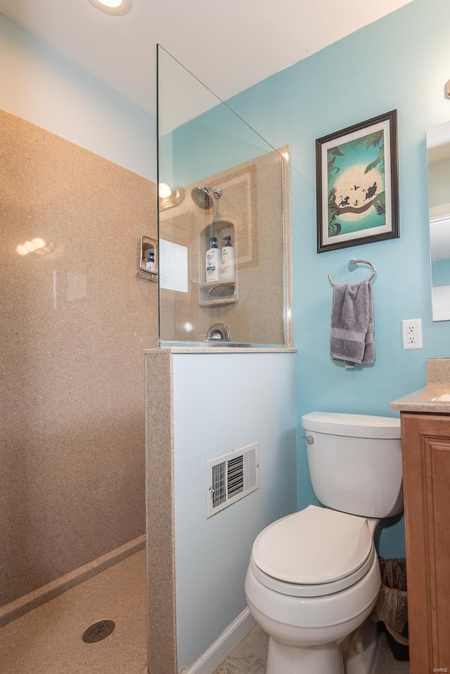 bathroom featuring toilet, walk in shower, vanity, and visible vents