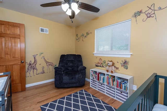 bedroom with ceiling fan, baseboards, visible vents, and wood finished floors