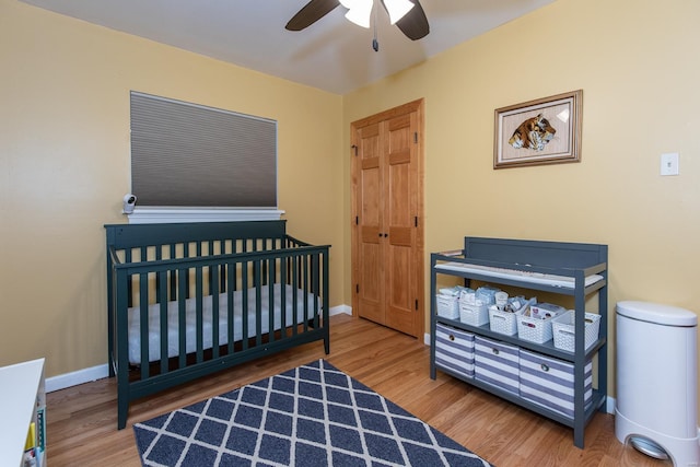 bedroom featuring baseboards, a ceiling fan, and wood finished floors