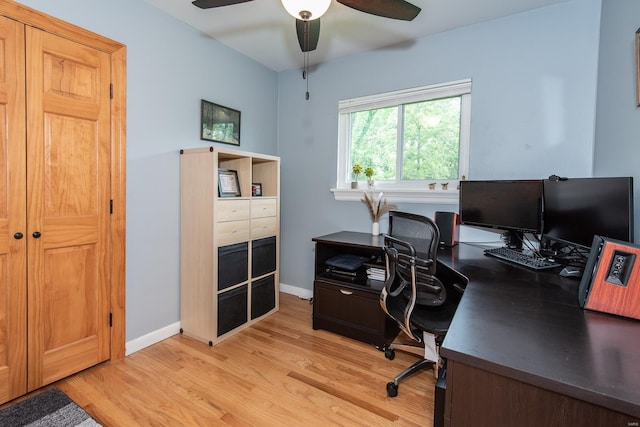 office area featuring a ceiling fan, baseboards, and light wood finished floors
