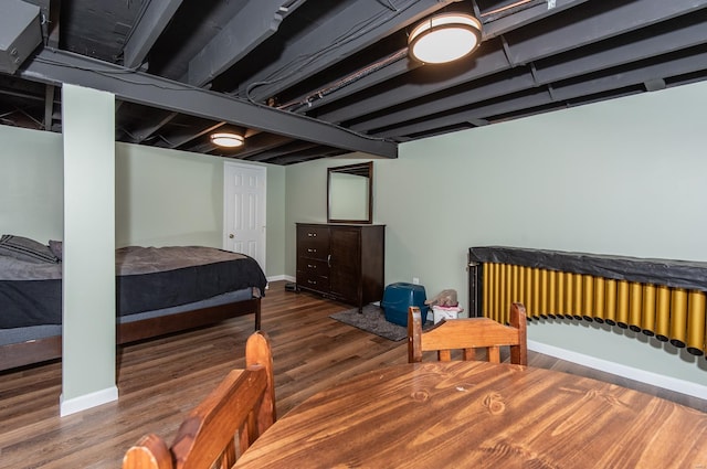 bedroom featuring baseboards and wood finished floors