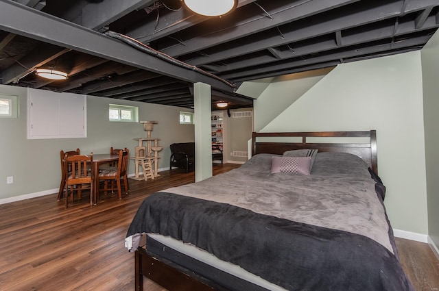 bedroom featuring baseboards and wood finished floors