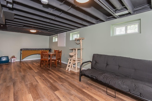 living area with wood finished floors, baseboards, and a healthy amount of sunlight