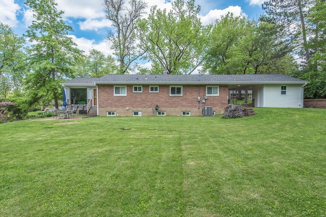 back of house with a yard, a patio area, cooling unit, and brick siding