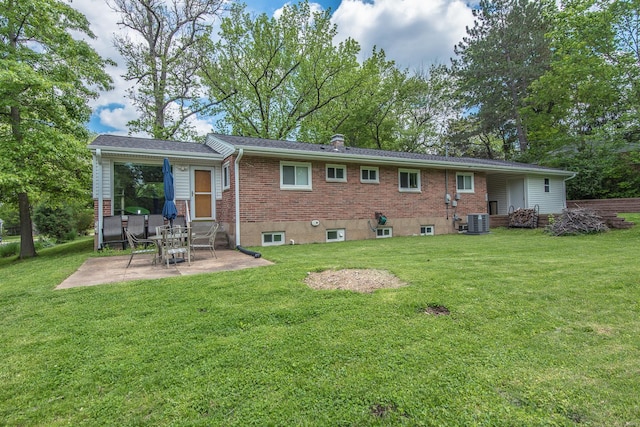 back of house with a yard, brick siding, a patio, central AC, and entry steps
