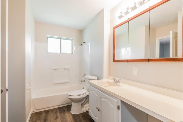 full bath featuring vanity, washtub / shower combination, toilet, and wood finished floors