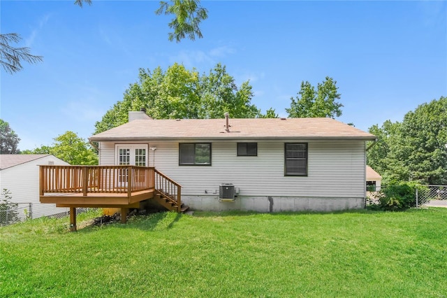 rear view of house featuring fence, central air condition unit, a lawn, and a deck