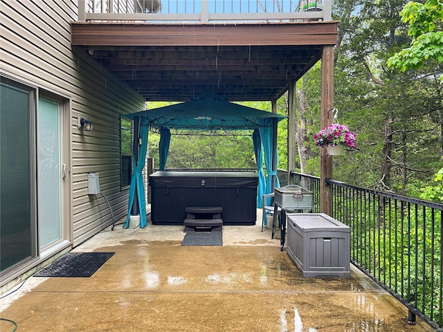 view of patio with a gazebo, a hot tub, and area for grilling