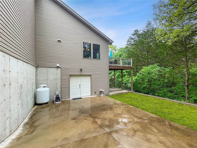 view of side of property featuring a patio area and a deck