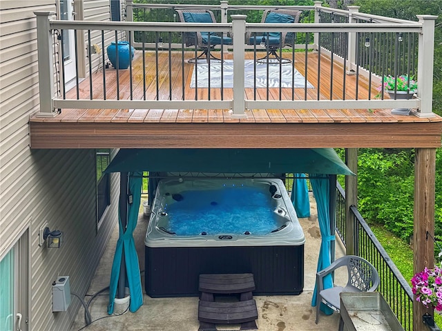 wooden terrace with a hot tub and outdoor dining area