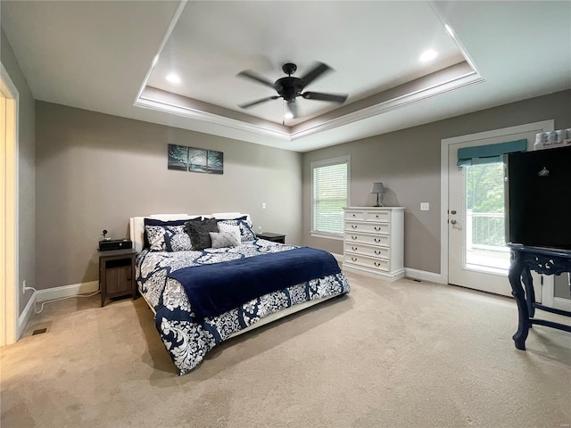bedroom with ceiling fan, light carpet, a raised ceiling, access to exterior, and baseboards