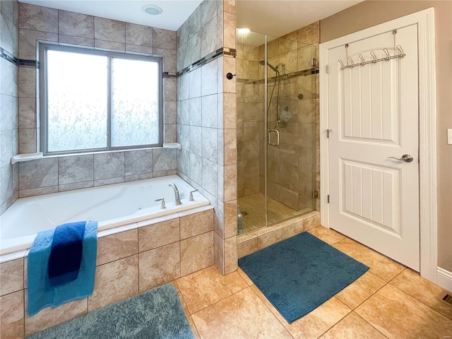 full bath featuring a bath, tile patterned flooring, and a stall shower