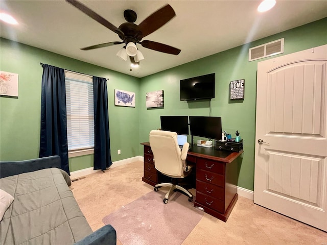 office area featuring baseboards, ceiling fan, light carpet, and visible vents