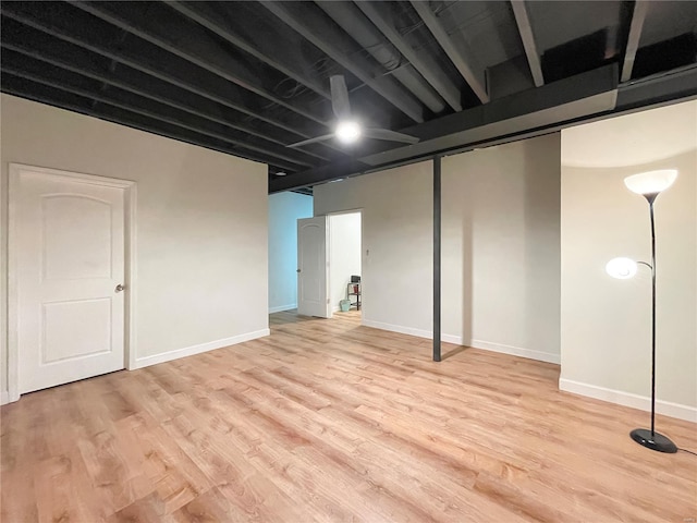 finished basement featuring baseboards and wood finished floors