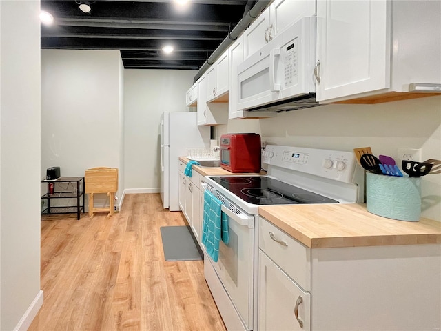 kitchen with white appliances, white cabinetry, wood counters, and light wood-type flooring