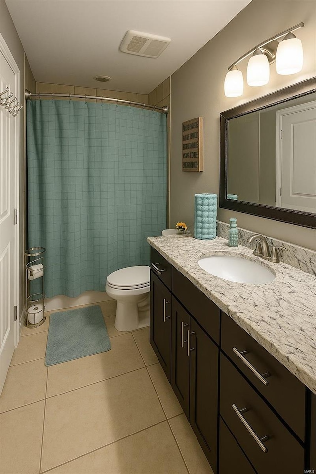 bathroom with visible vents, tile patterned floors, toilet, and vanity