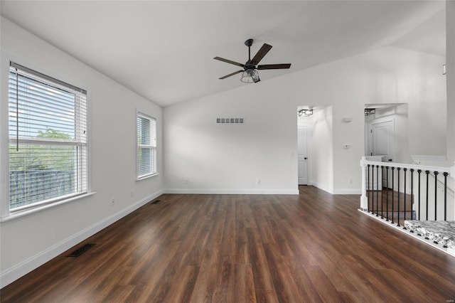 spare room featuring ceiling fan, vaulted ceiling, dark wood-style floors, and visible vents