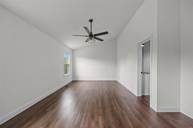 empty room featuring baseboards, a ceiling fan, dark wood finished floors, and lofted ceiling