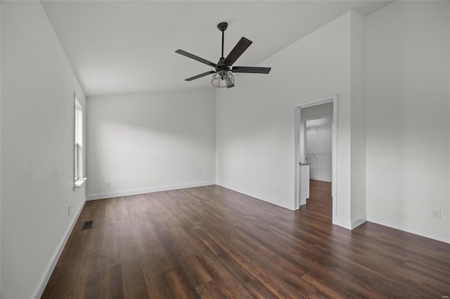 unfurnished room with ceiling fan, visible vents, dark wood finished floors, baseboards, and lofted ceiling
