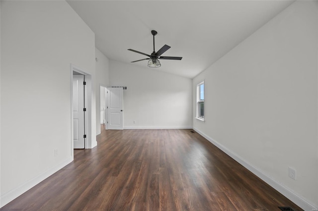 unfurnished room featuring baseboards, a ceiling fan, vaulted ceiling, and dark wood-style floors