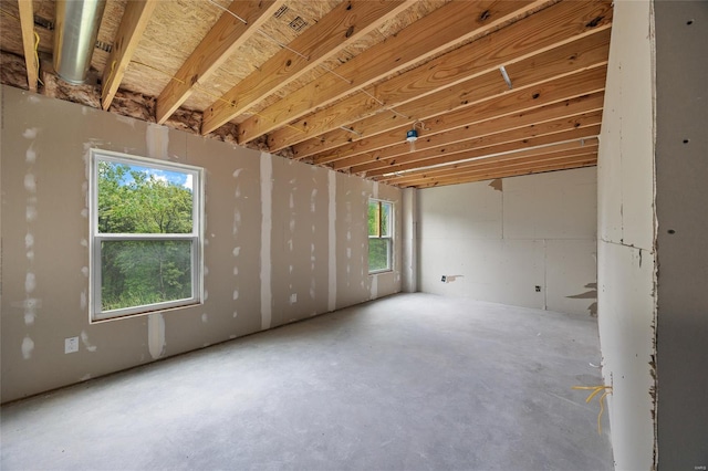 interior space featuring a wealth of natural light and unfinished concrete floors