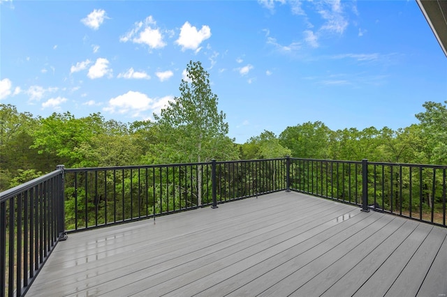 wooden terrace with a view of trees