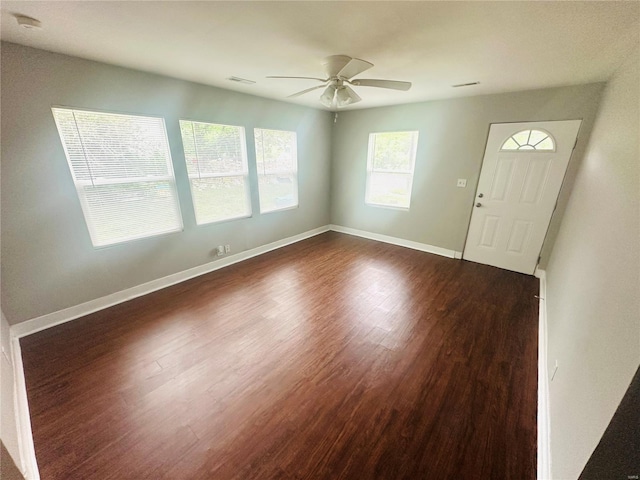 foyer featuring baseboards, a ceiling fan, dark wood-type flooring, and visible vents