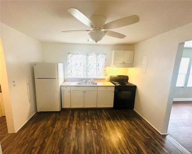 kitchen featuring freestanding refrigerator, a sink, dark wood-type flooring, and black range with electric stovetop