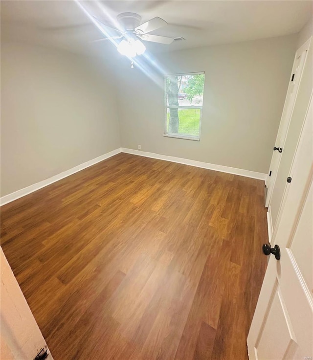 bonus room with baseboards, ceiling fan, wood finished floors, and vaulted ceiling