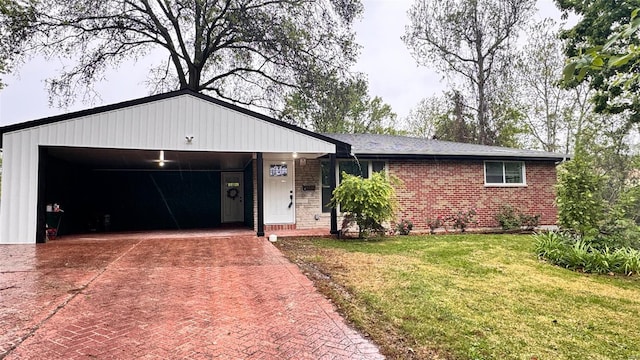 ranch-style home with brick siding, decorative driveway, an attached garage, and a front yard