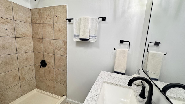 bathroom with a sink and tiled shower