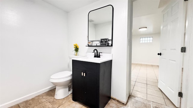 bathroom with toilet, baseboards, tile patterned flooring, and vanity