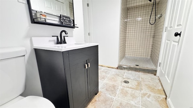 bathroom featuring vanity, a stall shower, and toilet