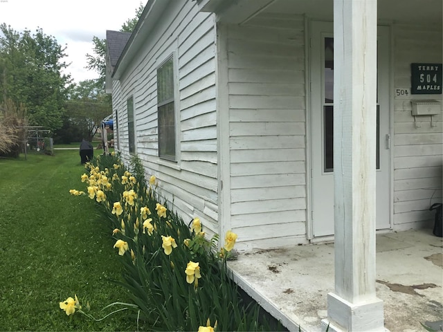 view of side of home featuring a yard