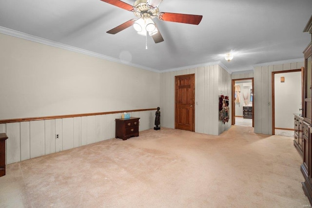 unfurnished bedroom with carpet floors, ceiling fan, and ornamental molding