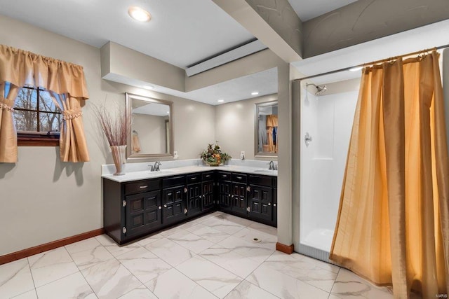 full bath with baseboards, a sink, and marble finish floor