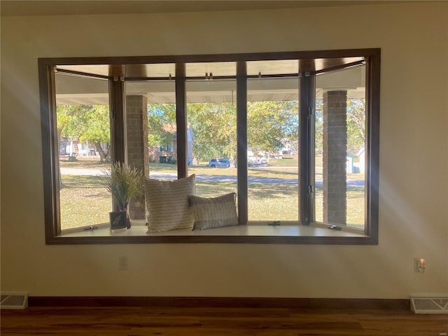 interior details with visible vents, baseboards, and wood finished floors