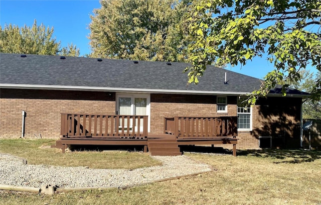 rear view of house with a wooden deck and brick siding