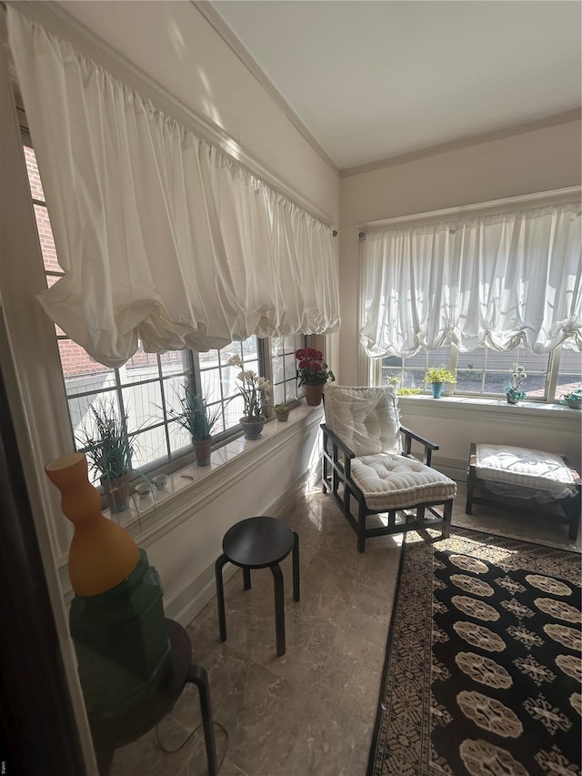 sunroom / solarium with baseboards and vaulted ceiling