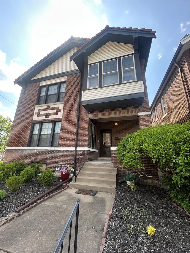 view of front of house with brick siding and covered porch