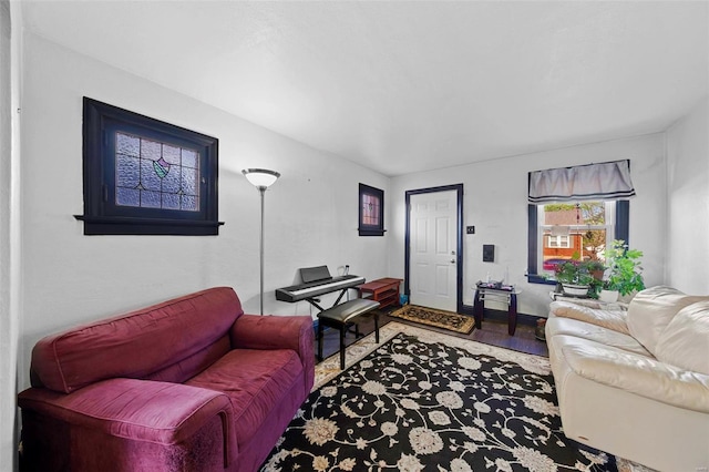 living area featuring baseboards and wood finished floors