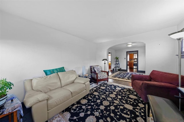 living area featuring arched walkways and a wealth of natural light